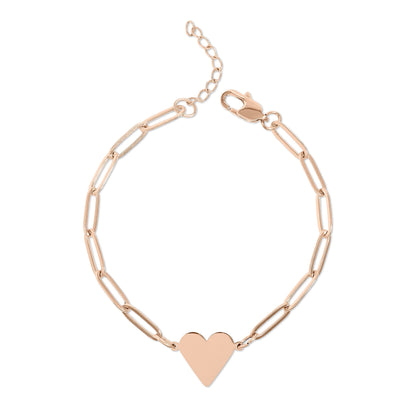Rose gold chain bracelet with a heart charm on a white background