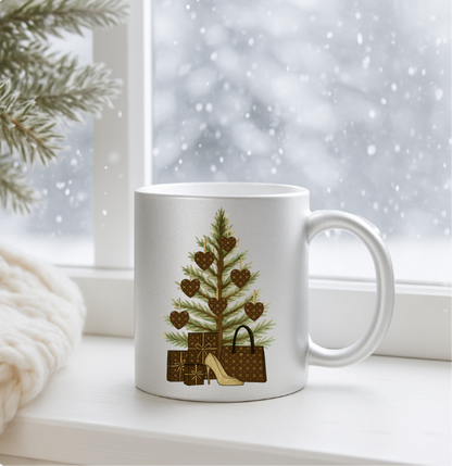 Silver mug with a Christmas tree and gift design on a windowsill with snow outside.