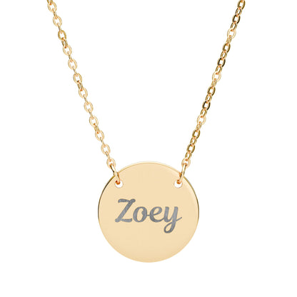 Gold necklace with a round pendant engraved with 'Zoey' on a white background