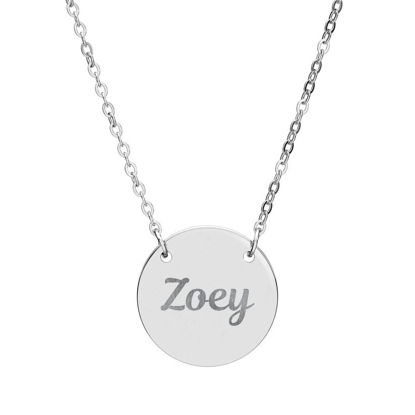 Silver necklace with a round pendant engraved with 'Zoey' on a white background