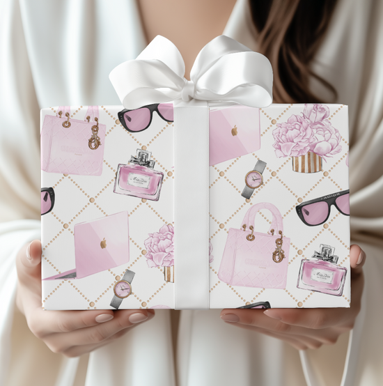 Gift box with pink fashion-themed design held by a person