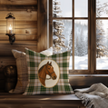 Decorative pillow with horse design on a wooden bench by a window with a snowy landscape view.