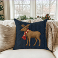 Decorative pillow with a moose design on a couch in a festive living room.