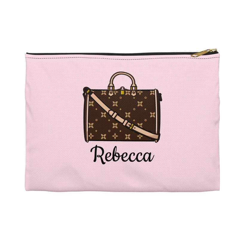Pink pouch with a brown suitcase design and 'Rebecca' text on a white background