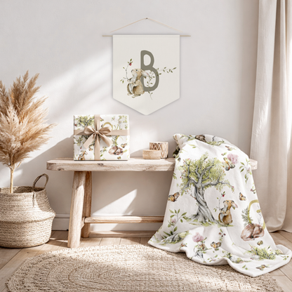 Nursery room with floral-patterned blanket, gift box, and decorative wall hanging.