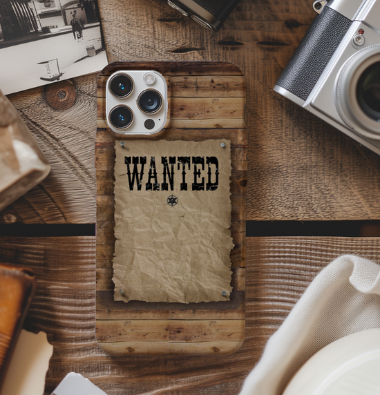Phone case with 'WANTED' text on a wooden surface with vintage items