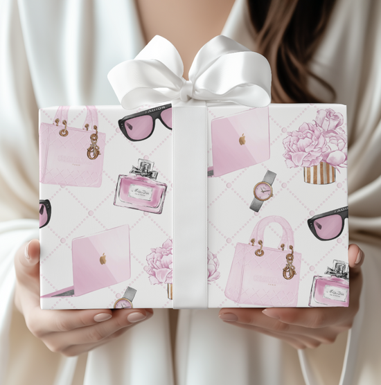 Gift box with pink fashion-themed design held by a person