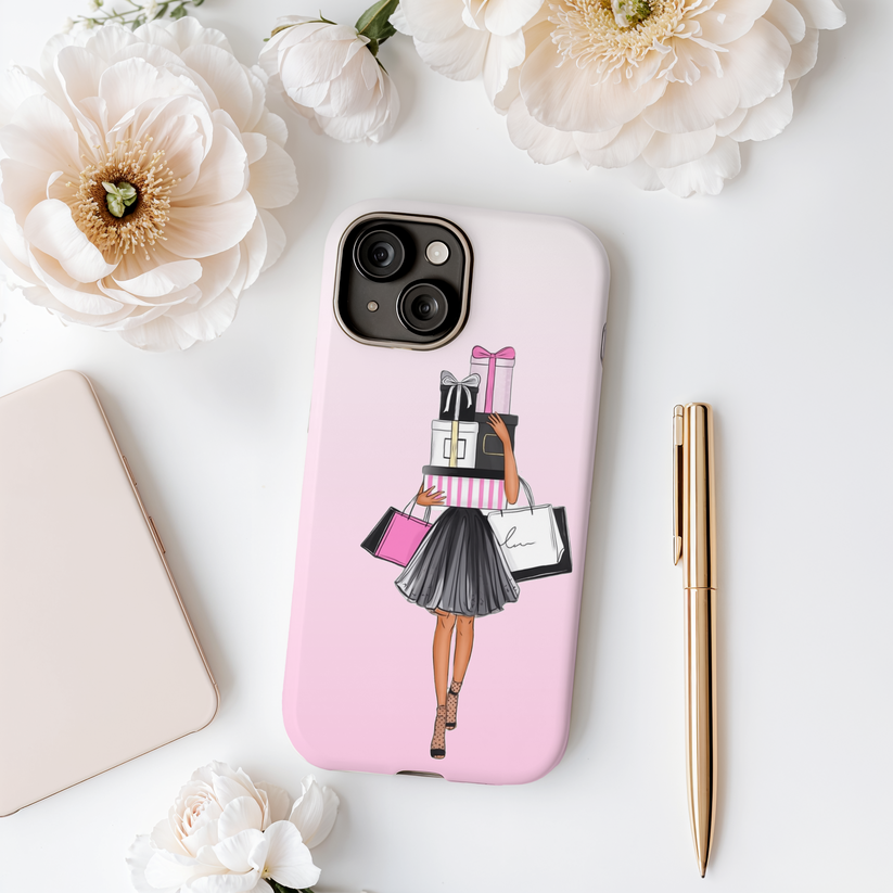 Phone case with a design of a woman holding bags on a pink background, surrounded by flowers and stationery items.