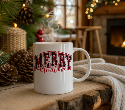 White mug with 'Merry Christmas' text in a festive setting with a Christmas tree and fireplace.