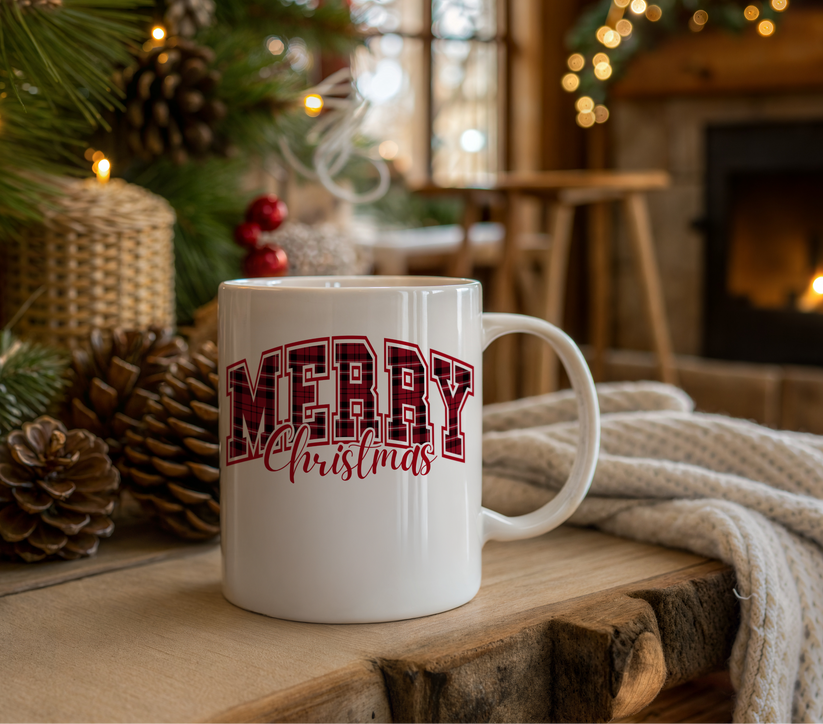 White mug with 'Merry Christmas' text in a festive setting with a Christmas tree and fireplace.