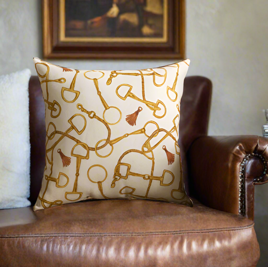 Decorative pillow with gold patterns on a brown leather couch