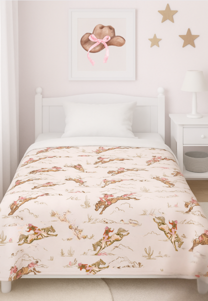 Children's bed with cowgirl patterned comforter in a room with star decorations on the wall.