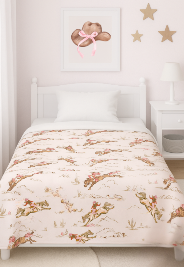 Children's bed with cowgirl patterned comforter in a room with star decorations on the wall.