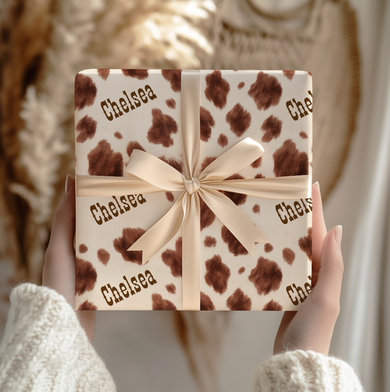 Gift box with brown and white appaloosa  pattern and 'Chelsea' text, held by hands..