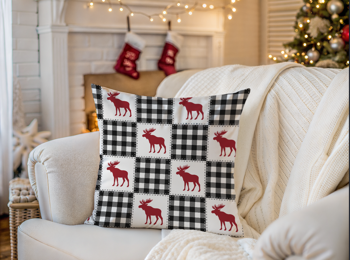 Decorative pillow with moose pattern on a white couch in a festive living room.