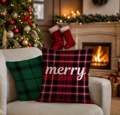 Red, white and black plaid pillow with the word "merry" in white sitting on a couch next to a black and green plaid pillow.