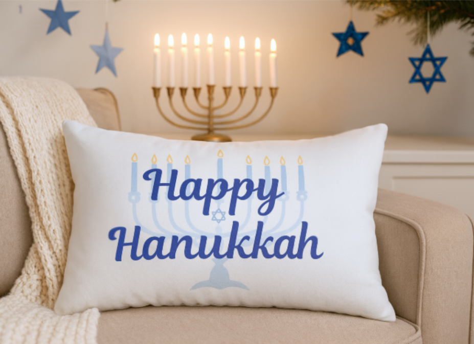Decorative pillow with 'Happy Hanukkah' text and Menorah design on a couch.