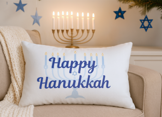 Decorative pillow with 'Happy Hanukkah' text and Menorah design on a couch.