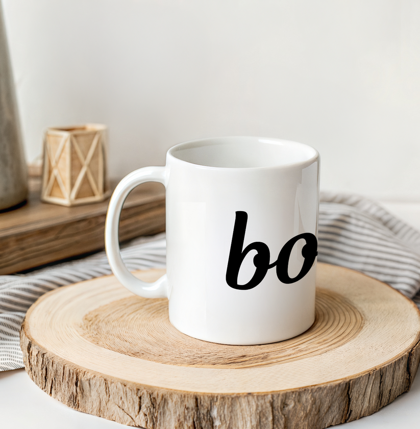 White mug with 'bo' on a wooden coaster