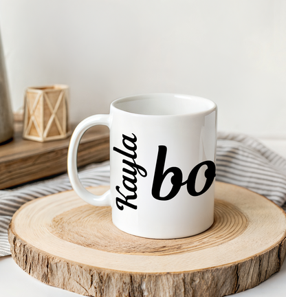 White mug with 'Kayla' and bonjour text on a wooden coaster