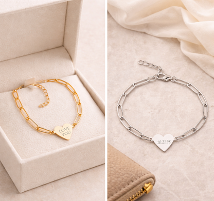 Two gold and silver bracelets with heart-shaped charms on a beige fabric background.