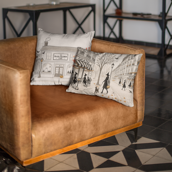 Brown armchair with patterned cushions in a room with a bookshelf and artwork.